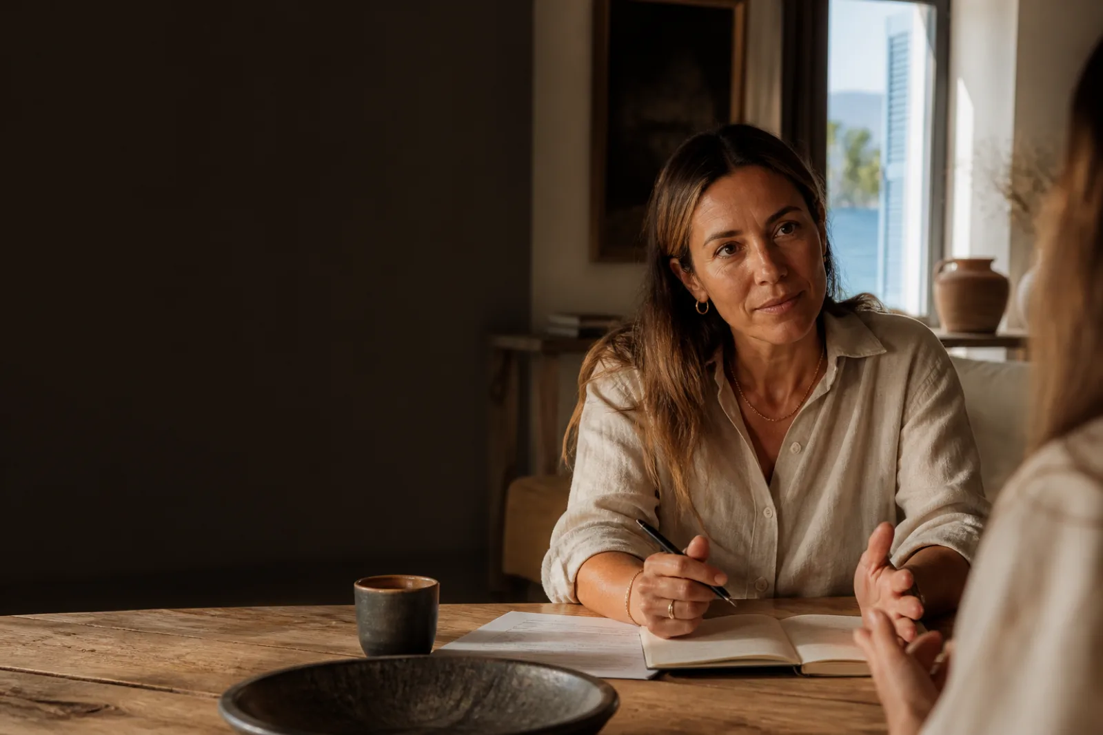 A hospitality operator speaking with a colleague across a table